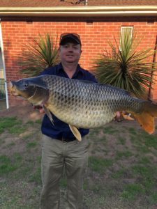 A man holding a 9kg European Carp in his arms